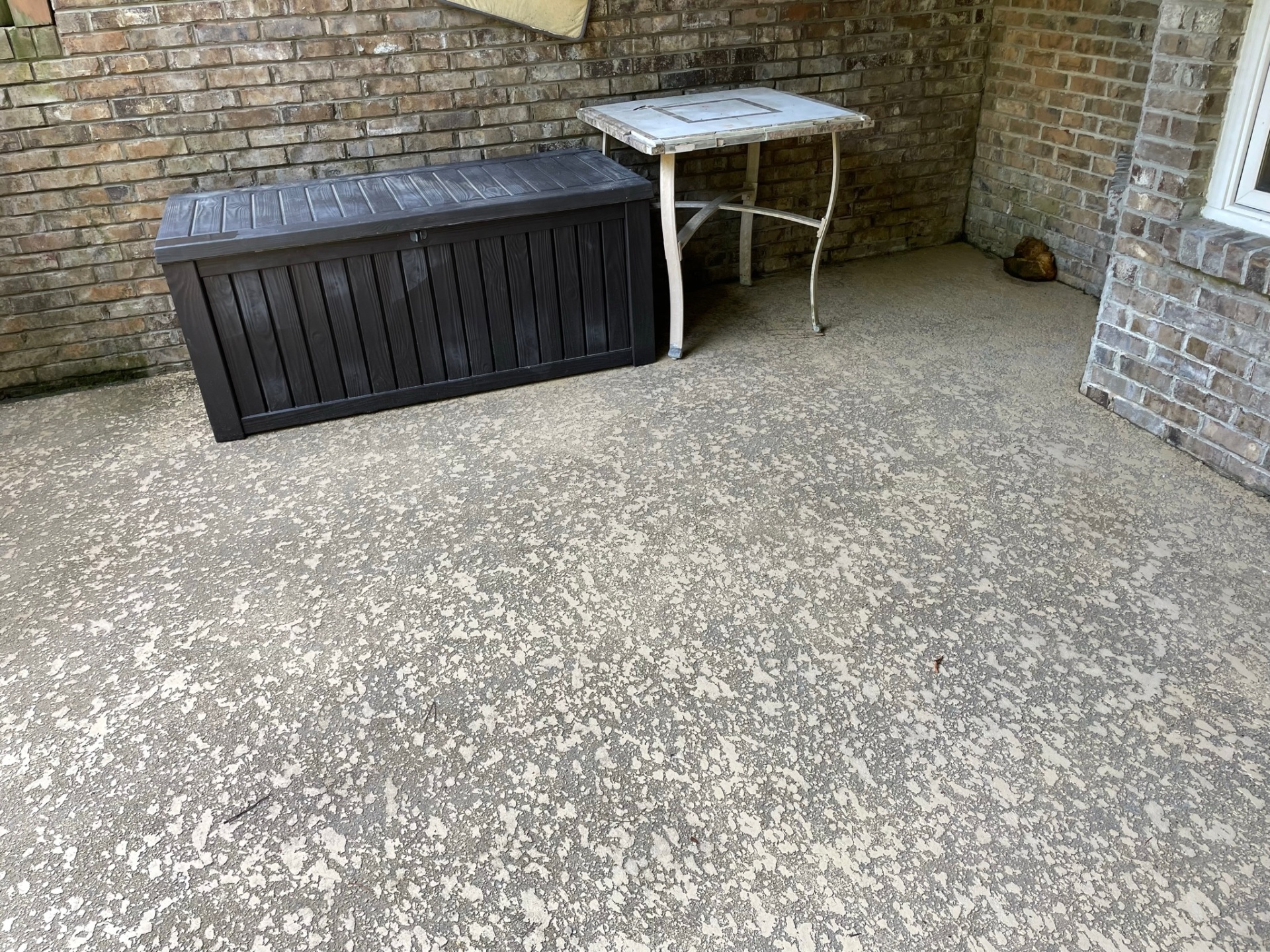 Same brick patio after pressure washing, algae and grime removed