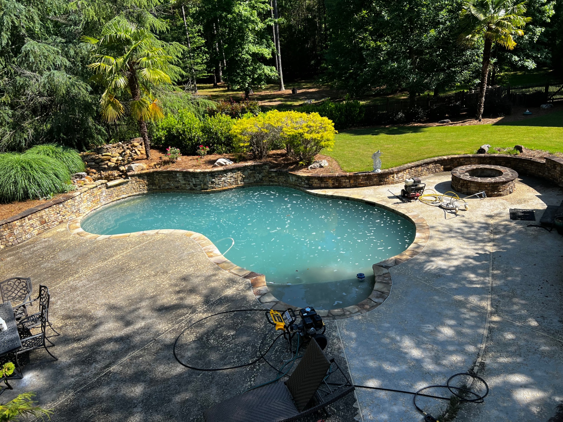 Pool deck — left half before pressure washing, right half after